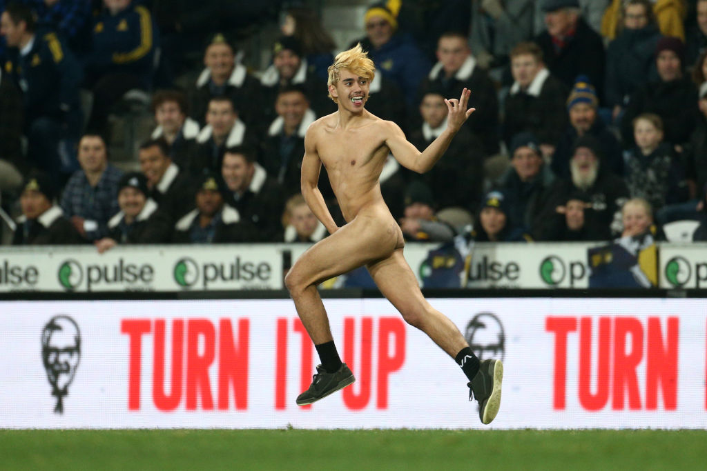 A streaker runs on to the field during the match between the Highlanders and Chiefs at Forsyth...