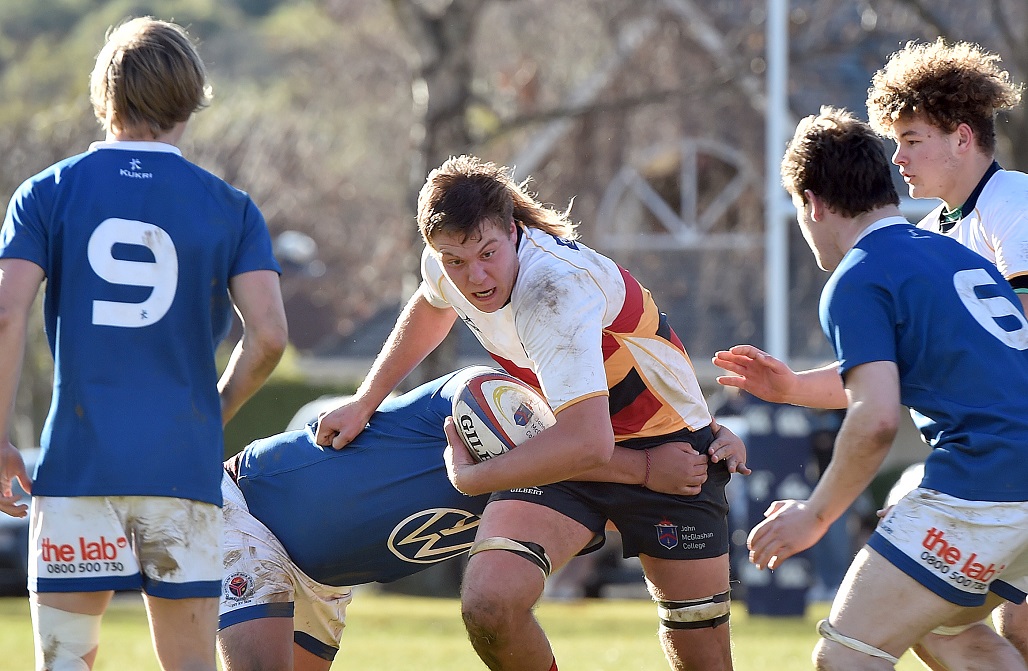 John McGlashan College's Harrison Morton runs the ball up against Southland Boys' High School at...