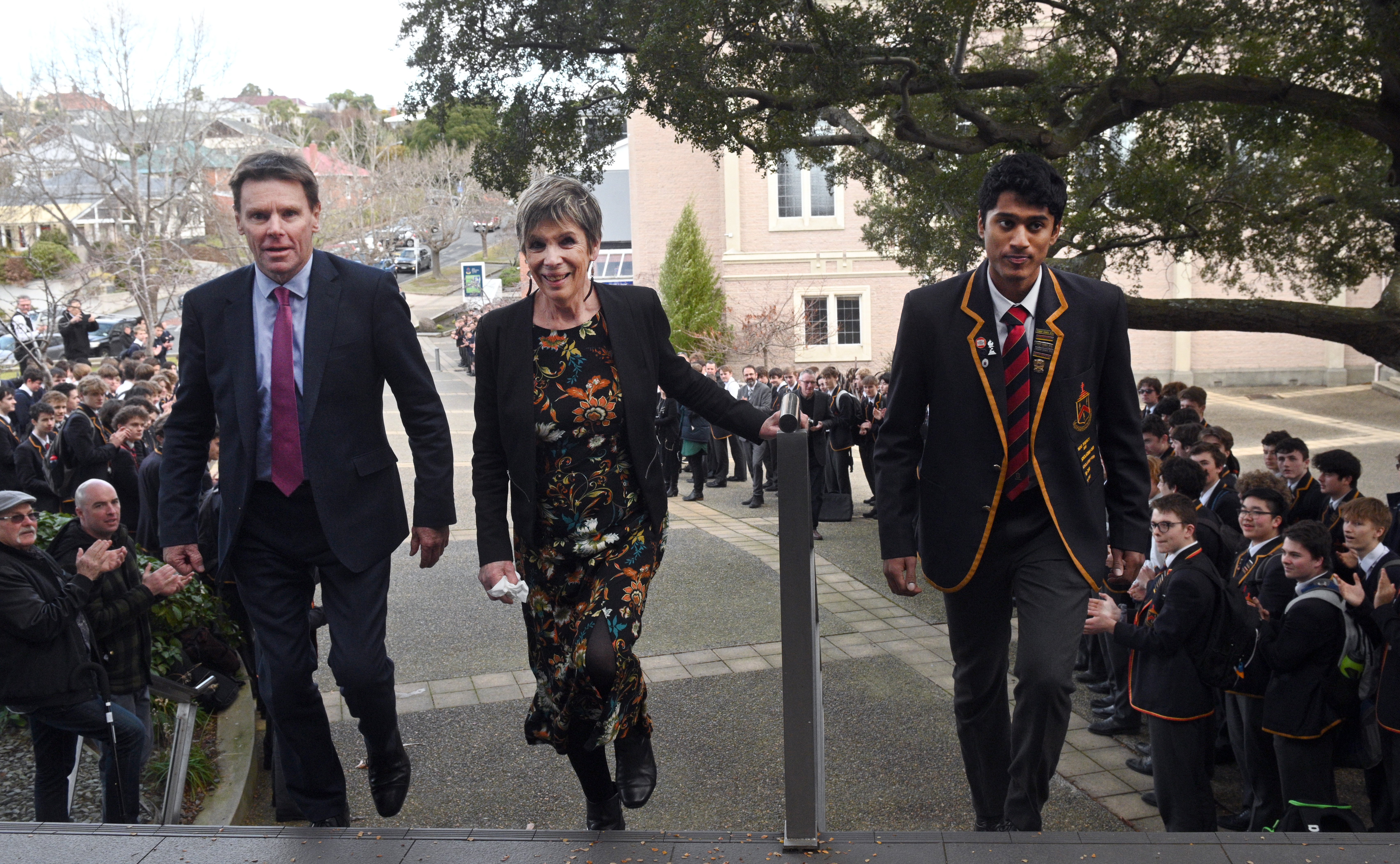 John McGlashan College personal assistant Jan Owen (centre) walks through a guard of honour with...