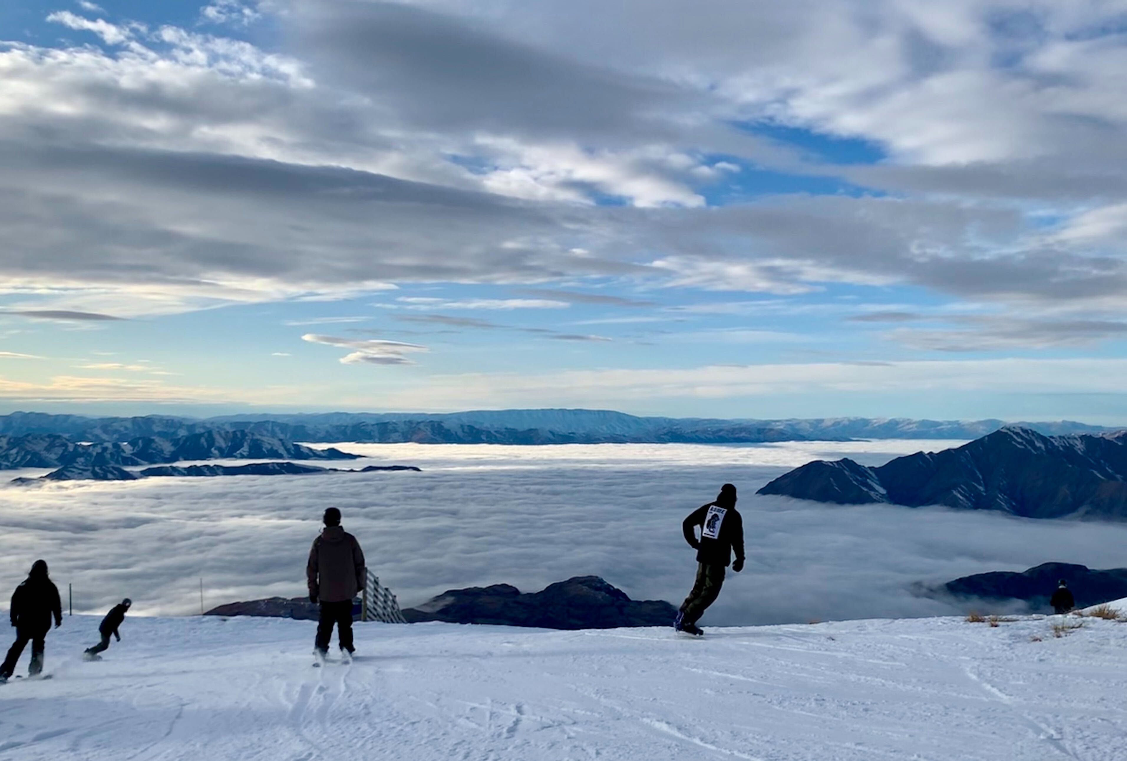 Early snowboarders and skiers take to Treble Cone's Triple Treat slopes on the opening day on...