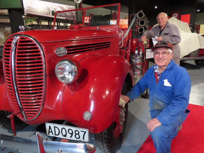 Ian Moore (front) and Bill Hart prepare the Ford V8 fire truck for ceremonial duty on Saturday at...