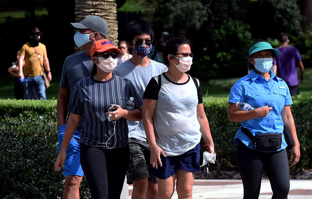 People wearing face masks walk at Lake Eola Park in Orlando, Florida. Photo: Getty Images