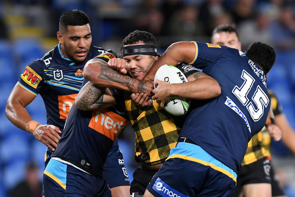 The Warriors' Jazz Tevaga is caught by the Gold Coast defence. Photo: Getty Images