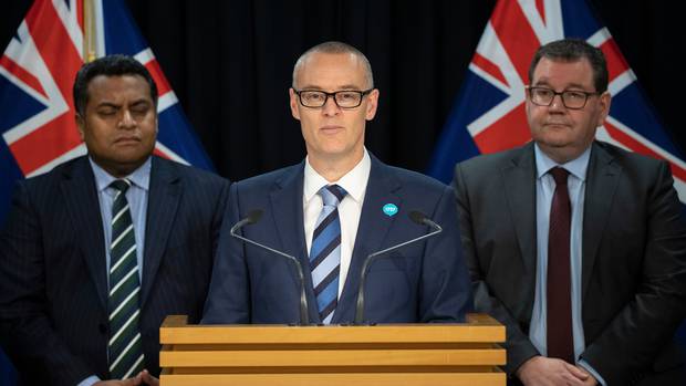 David Clark, flanked by Cabinet colleagues Kris Faafoi (L) and Grant Robertson, announced his...