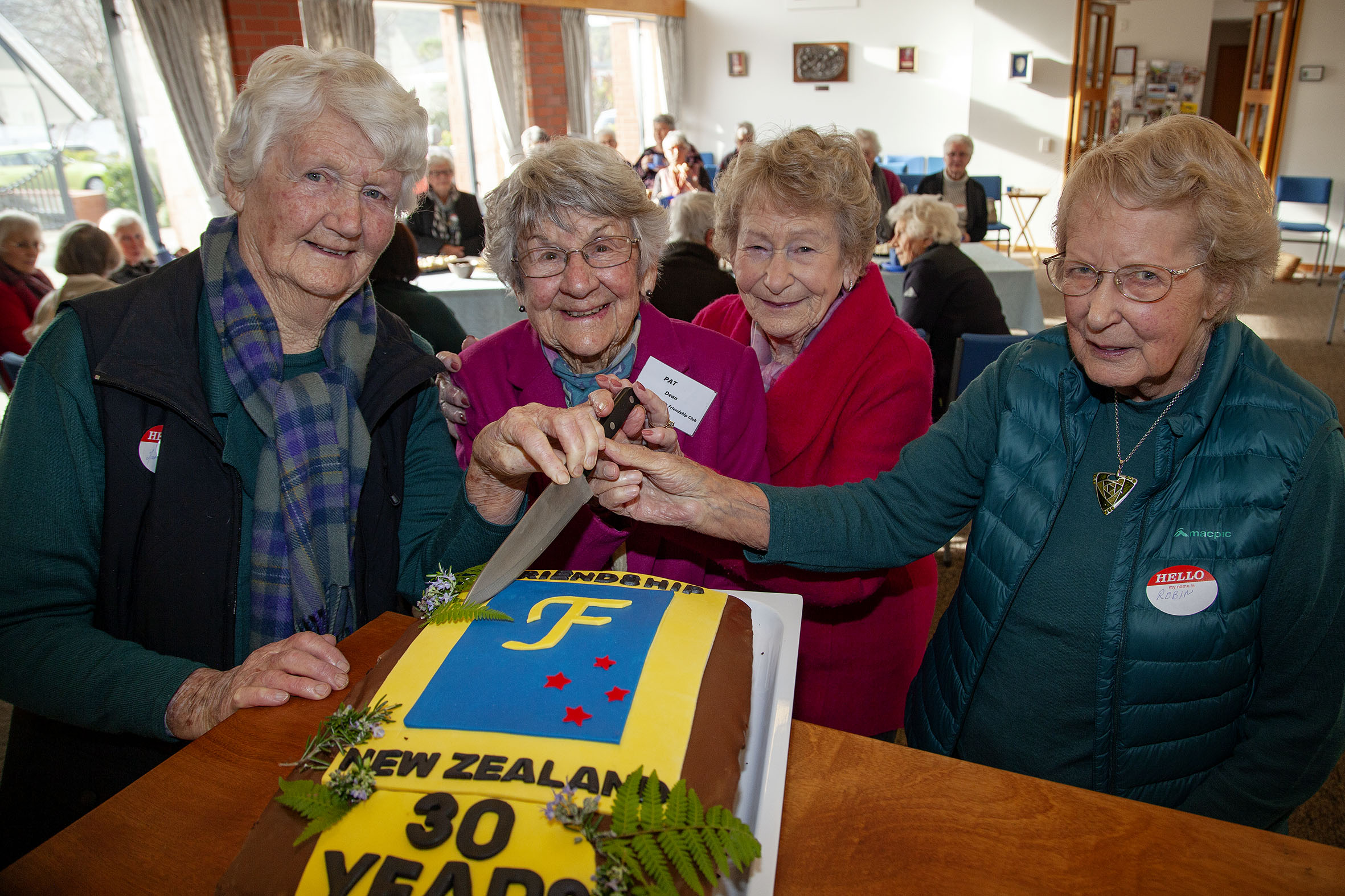 Marie Parry, 94, Pat Dean, 93, Fay Simon, 90, and Robyn Gosset, 89, cut into a special cake to...