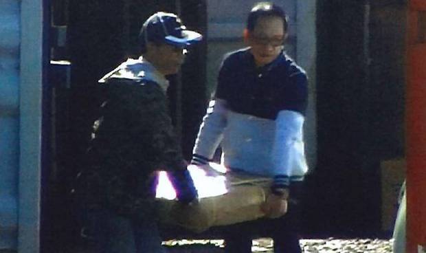 Chiu Tai Fi, left, and Ricky Leung caught on camera loading methamphetamine infused umbrella...