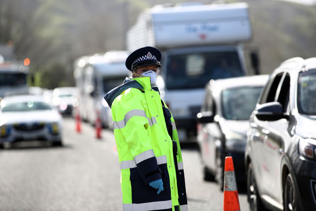 Police stop vehicles at a checkpoint on State Highway 1 near Wellsford north of Auckland on...