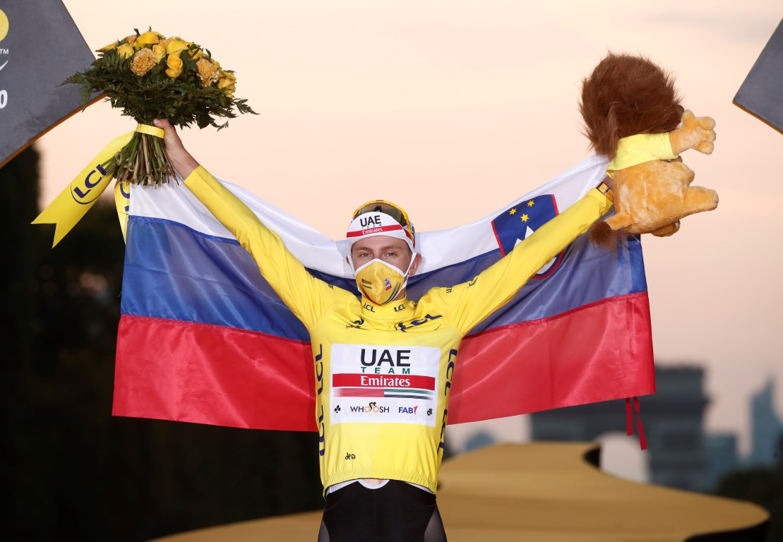 Tadej Pogacar celebrates his victory on the podium. Photo: Reuters