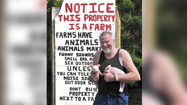 Pig farmer Pieter Bloem with the "educational" sign outside his Otago Peninsula property. Photo:...