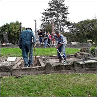 Volunteers repairing headstones and graves in Akaroa. Photo: Supplied