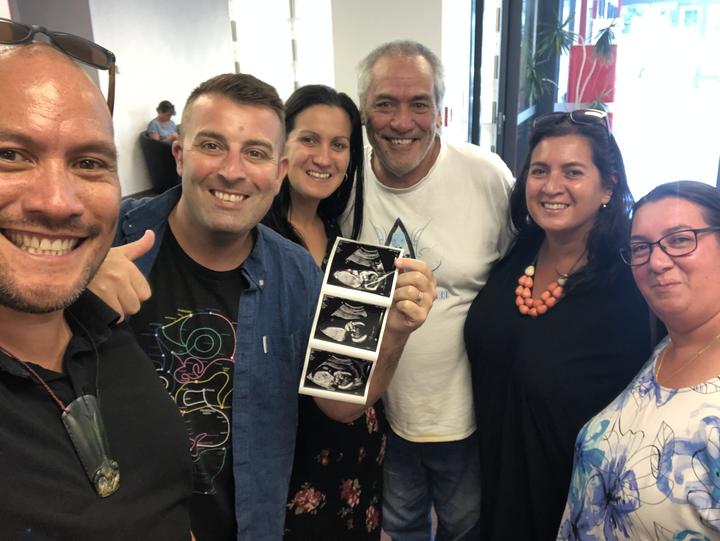 Tamati Coffey (left) with partner Tim Smith and surrogate mother Natasha Dalziel at their baby...