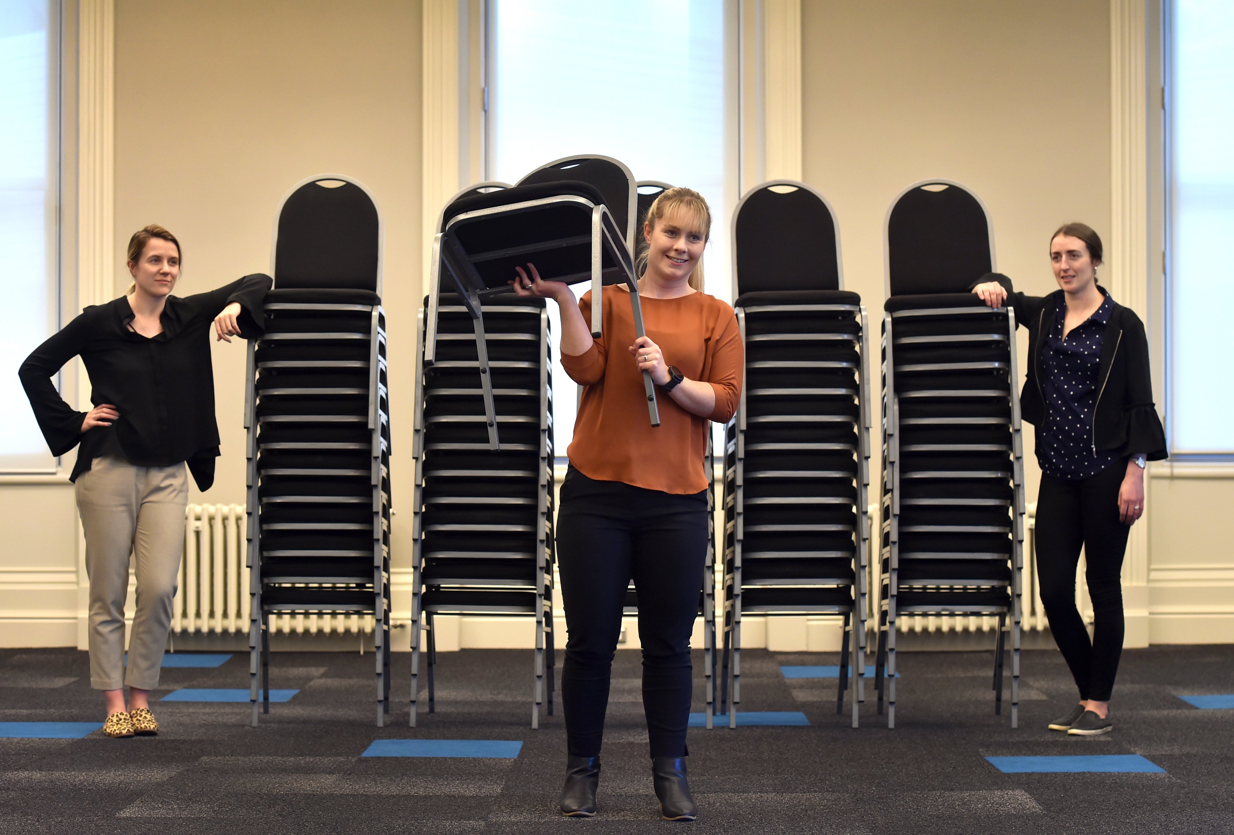 Chairs remain stacked up at the Dunedin Centre but members of the Dunedin Venues team (from left)...