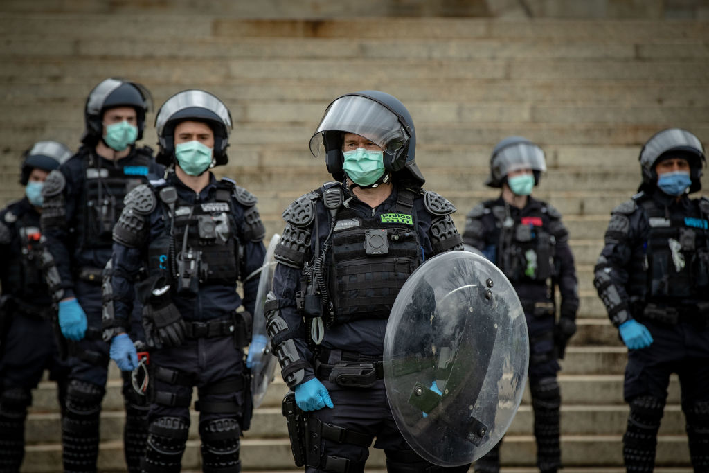 Police officers patrol the Shrine of Remembrance during an anti-lockdown rally in Melbourne on...
