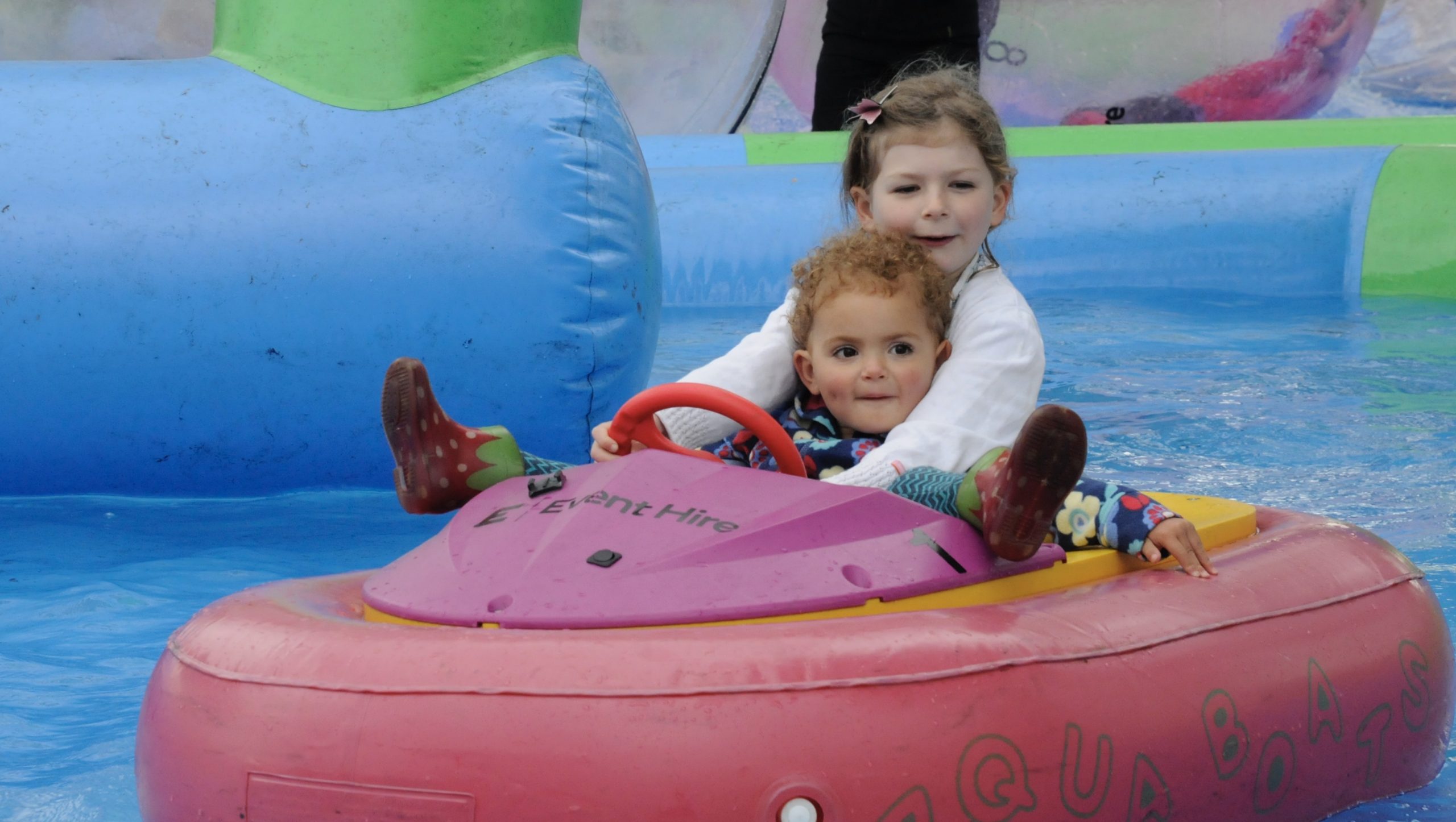 Edie Barber, 6, with her cousin Willow Henson, 2, in an Aqua Boat during last year's Party in the...