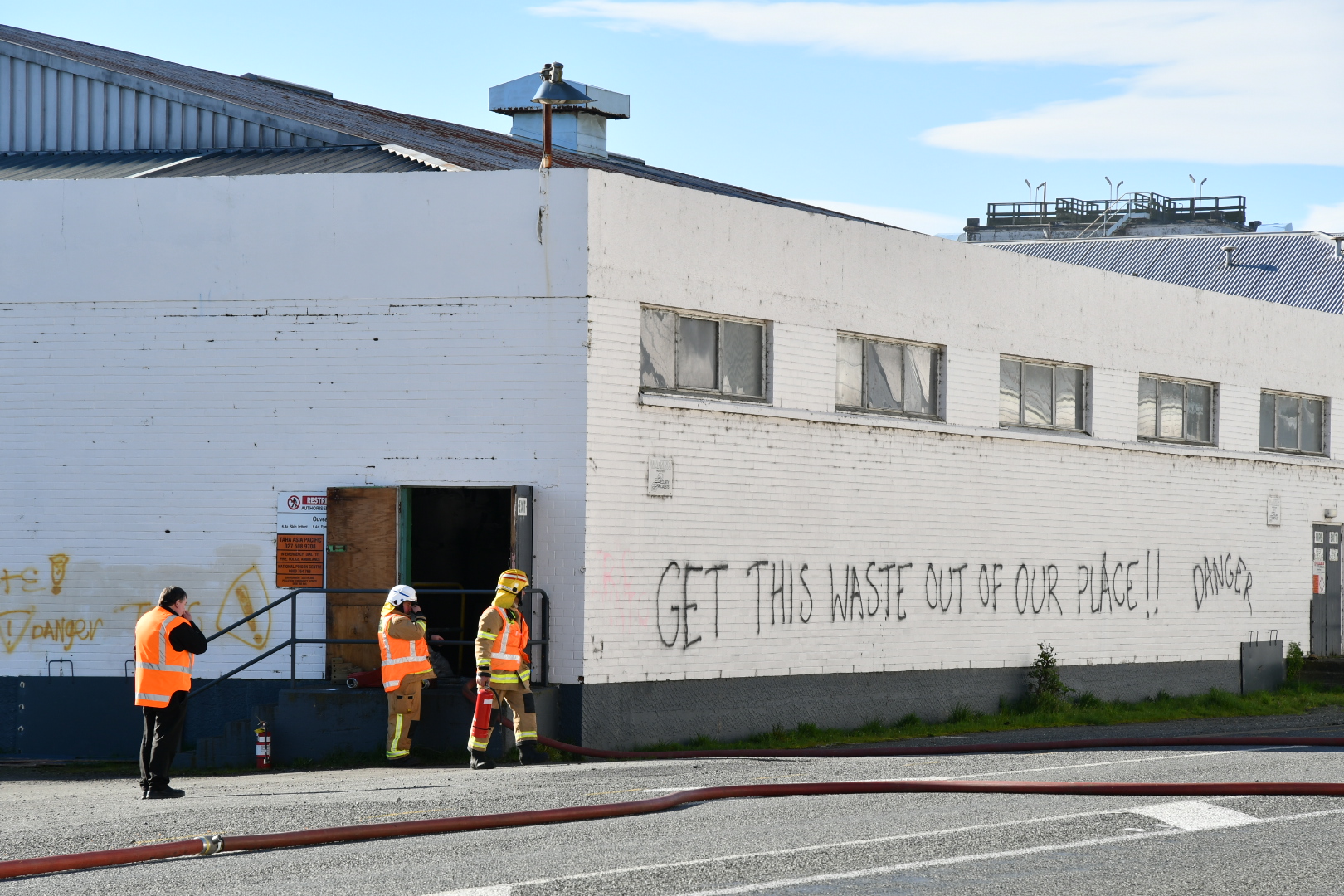 Firefighters at an entrance to the building holding toxic 'premix' in Mataura. Photo: Laura Smith...