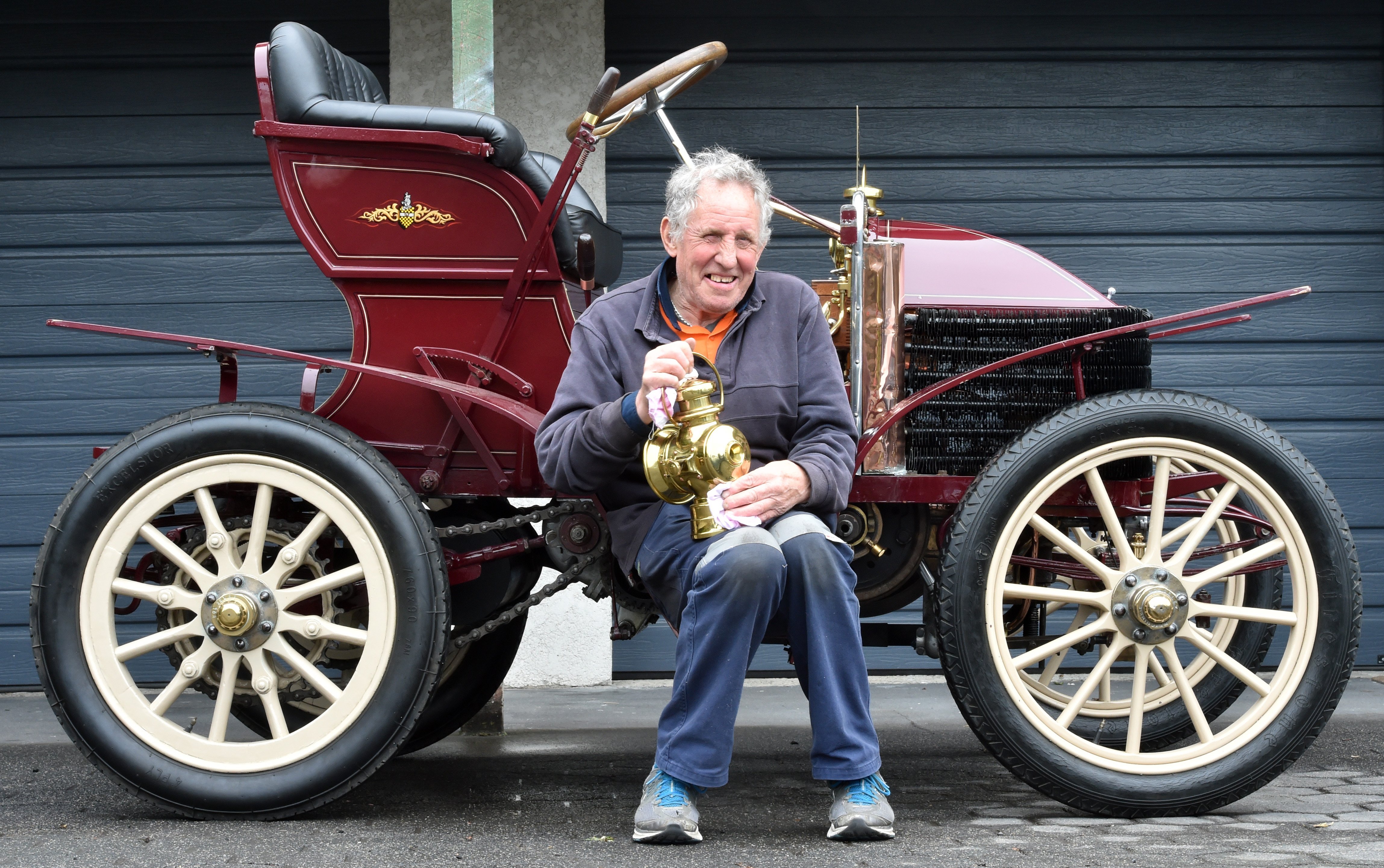 Colin Winter polishes alantern from his 1900 Wolseley (nicknamed Grandma), in preparation for the...