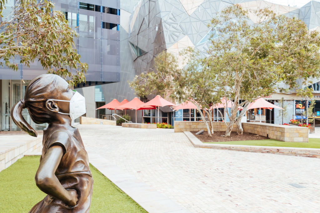 A masked statue of Fearless Girl in Melbourne's Federation Square. Photo: Chris Putnam/Barcroft...