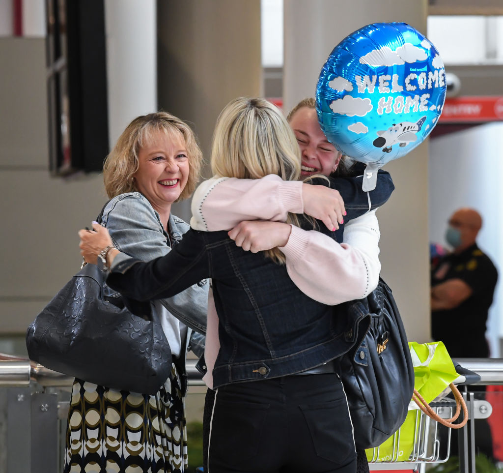 Friends greet each other at Sydney's Kingsford Smith Airport after the first flight from New...