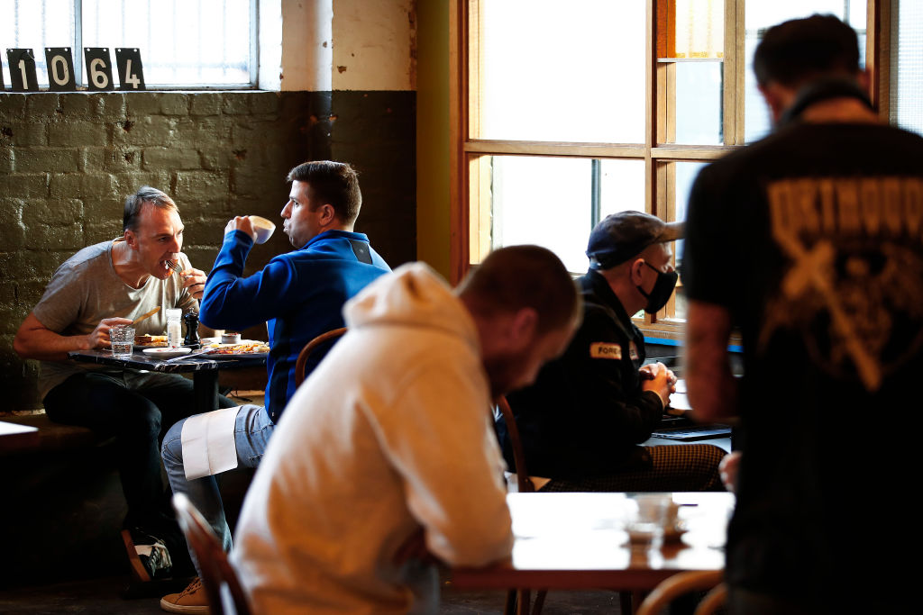 People dine in a cafe in Melbourne, where lockdown conditions have been lifted. Photo: Getty