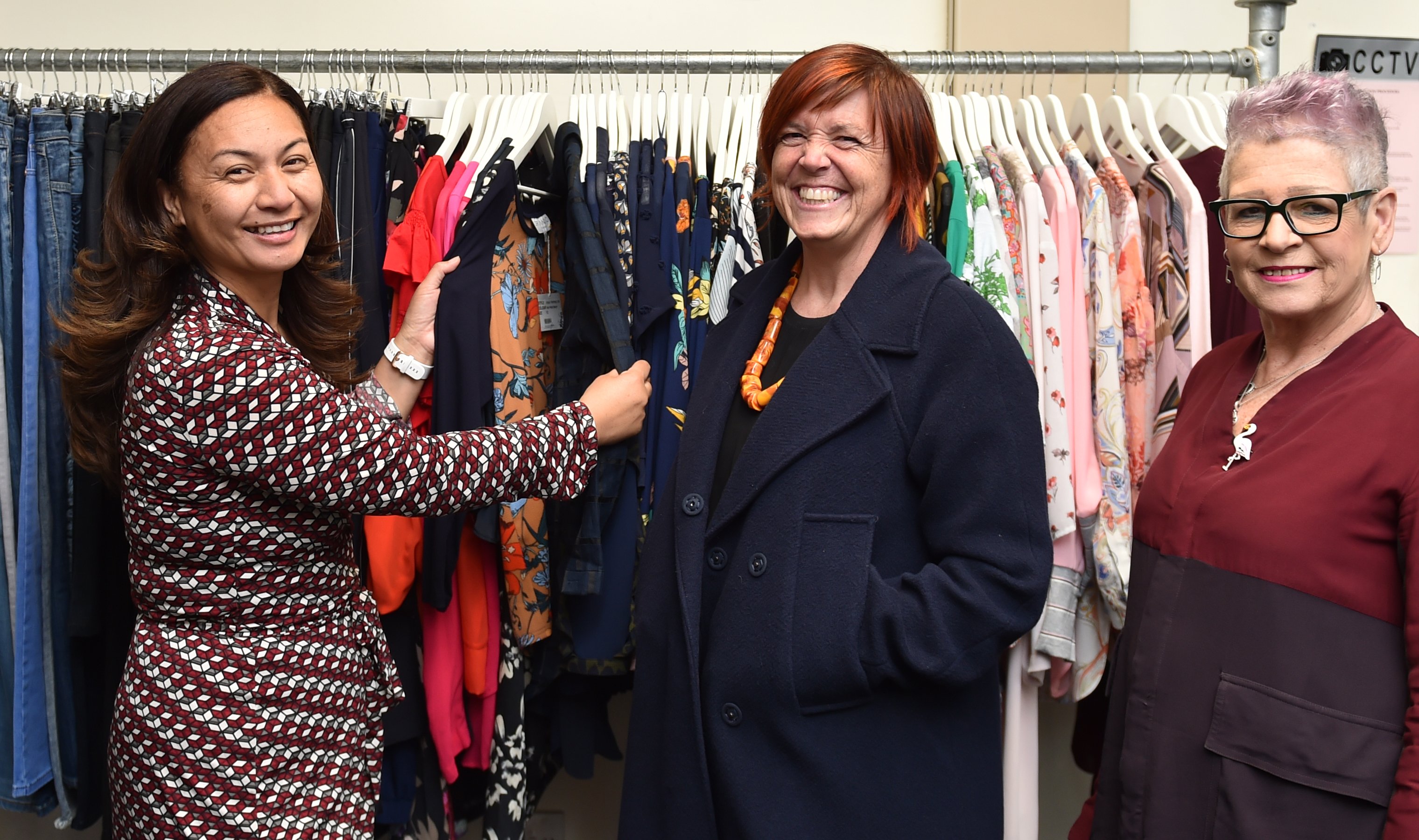 Green Party co-leader Marama Davidson (left) checks clothing at the Inside Out Clothing shop in...