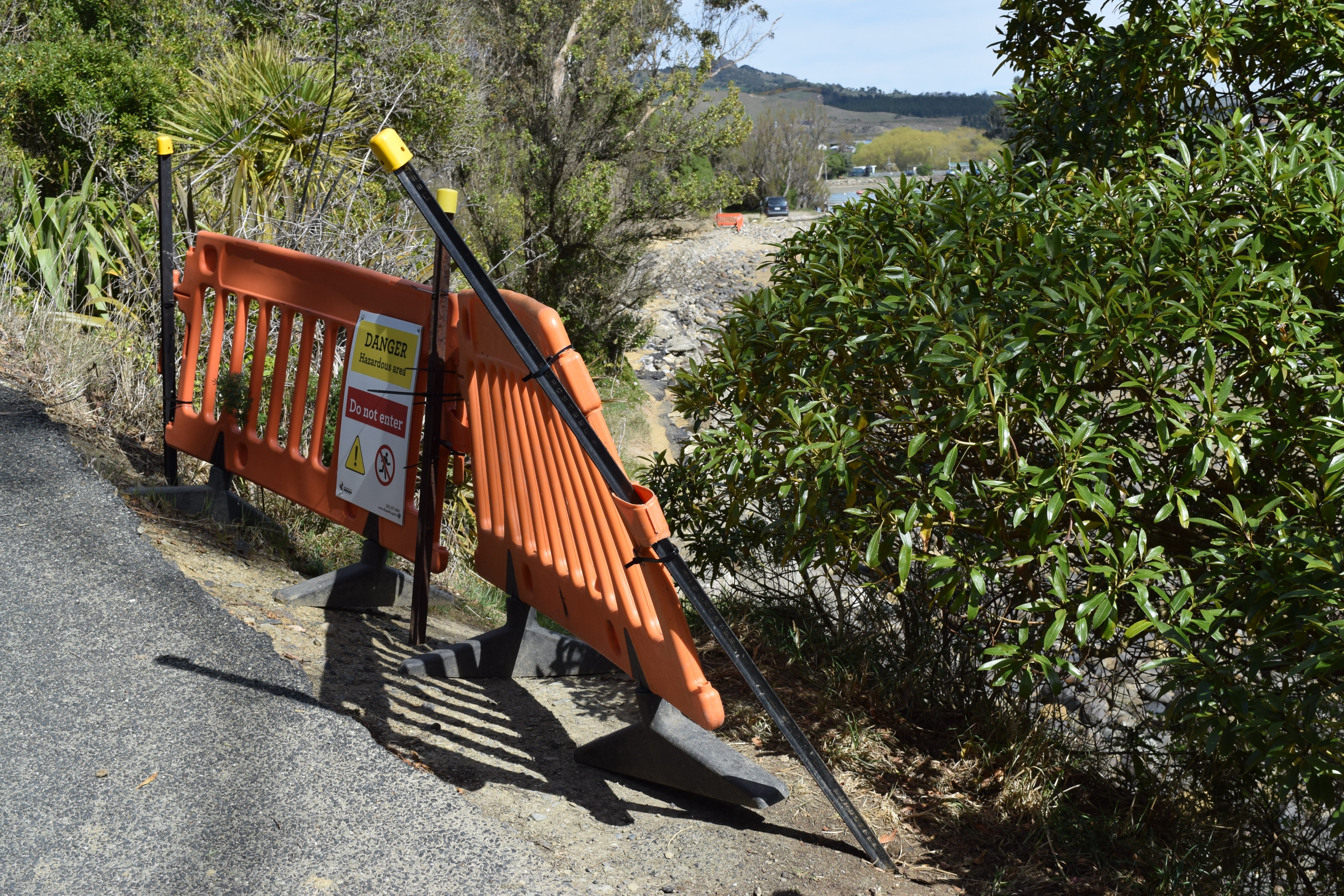 A sign on a barrier warns against using a walkway in Karitane. PHOTOS: SHAWN MCAVINUE