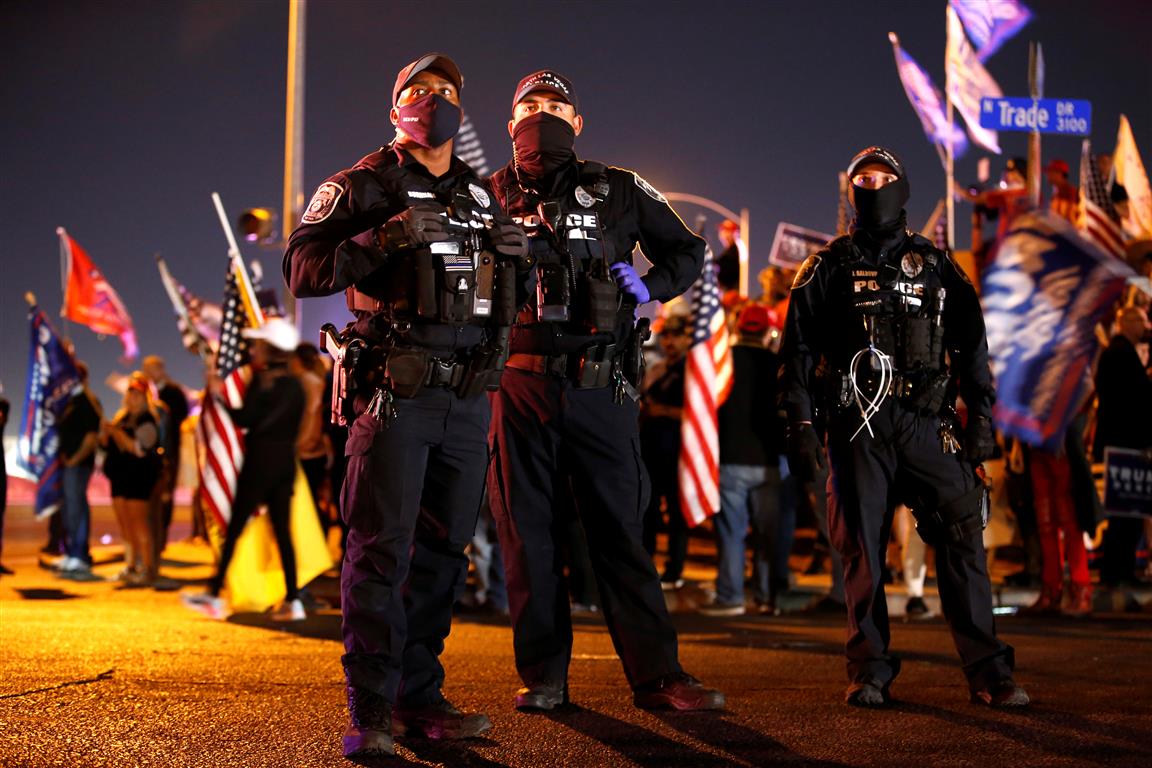 Police officers at the ready during a "Stop the Steal" protest at Clark County Election Center in...