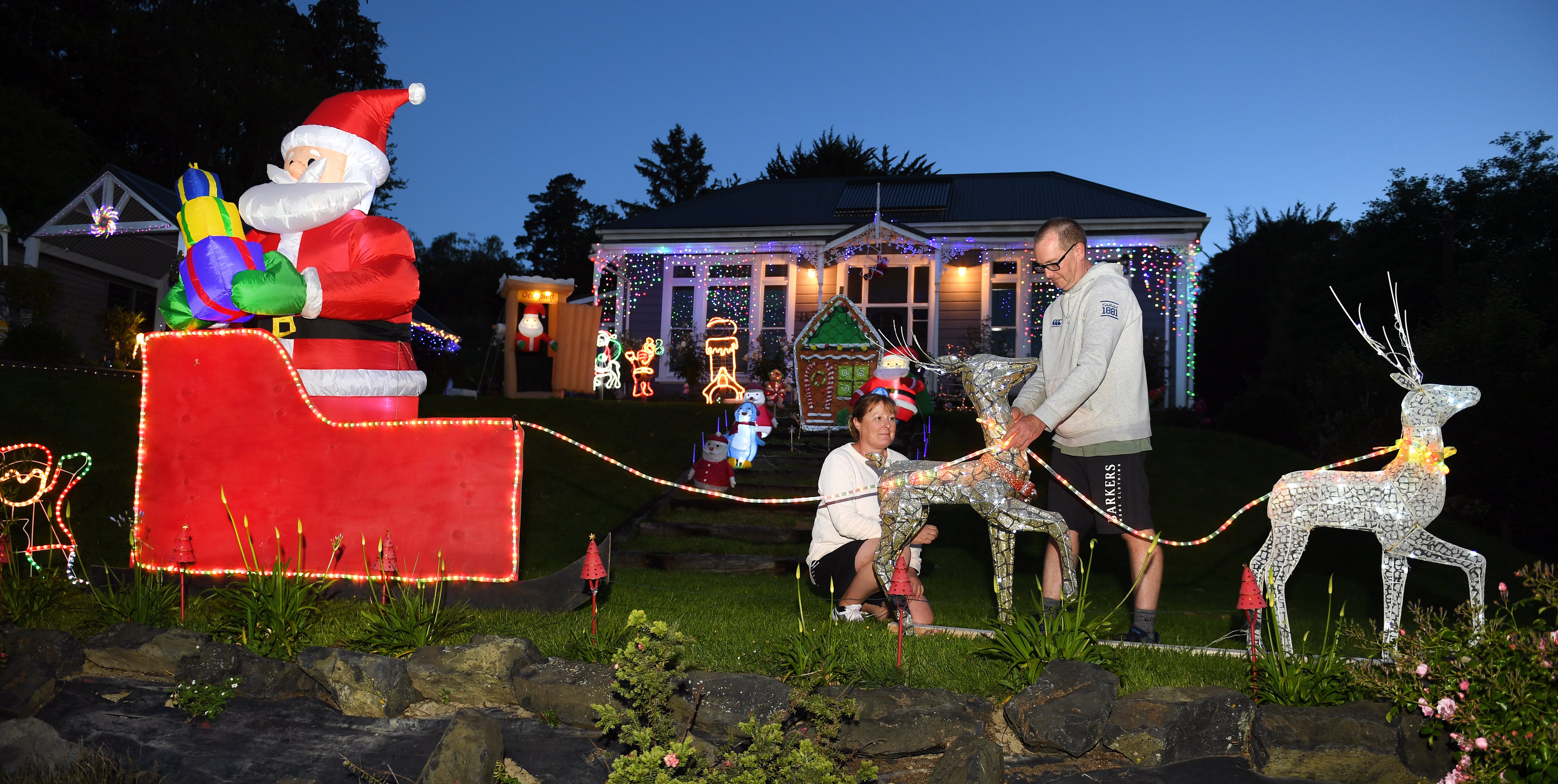 Faye Hammond and partner Richard Milmine put the finishing touches to their Christmas display, in...