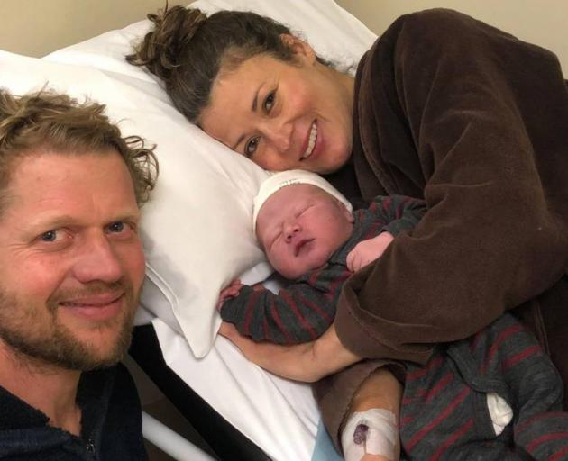 Kristi James with her partner and son, after she delivered in her midwife's office. Photo: Supplied