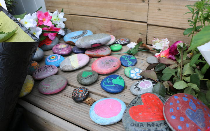 Flower and messages of support were laid outside Linwood Ave mosque, a year on from the shootings...