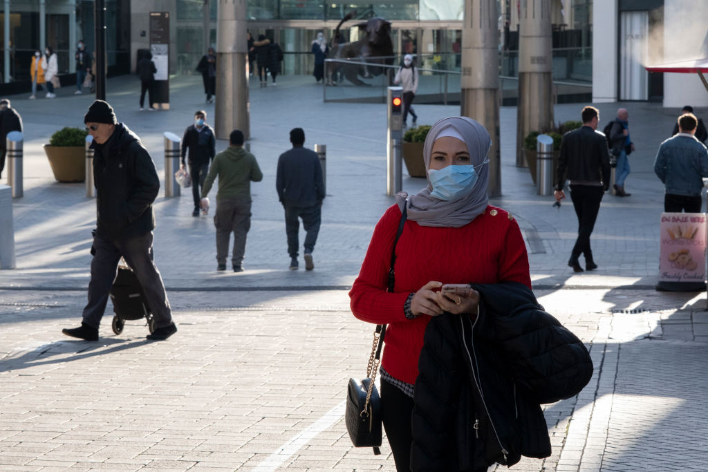 People wearing face masks in the Bull Ring shopping area of Birmingham on the day it was...