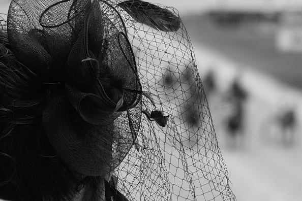  A racegoer follows the action during New Zealand Trotting Cup Day at Addington Raceway. Photo by...