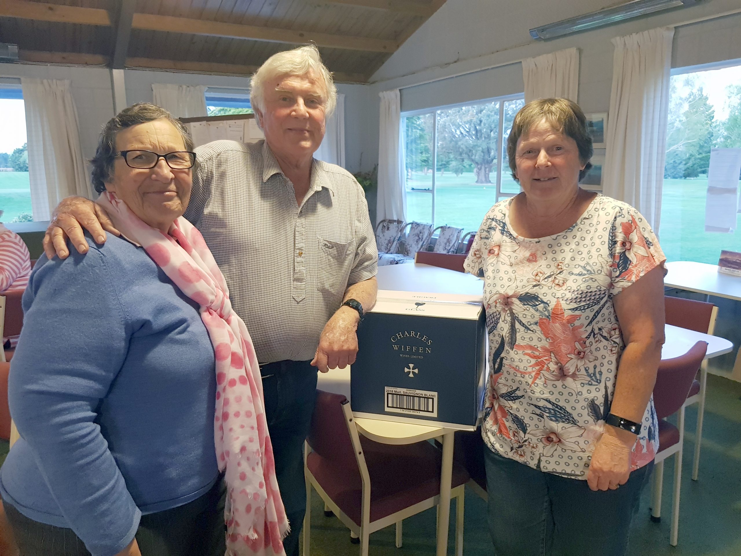 Di Yates, left, with Sandy and Charles Wiffen, and one of the boxes of sauvignon blanc she...