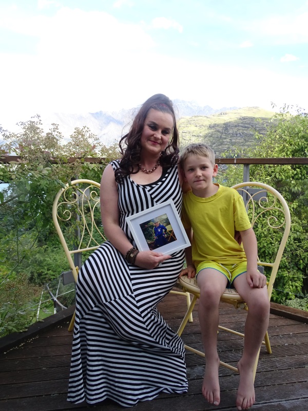 Queenstown resident Peggy Hieronymus clutches a picture of her stranded daugther, Xavion, 11,...