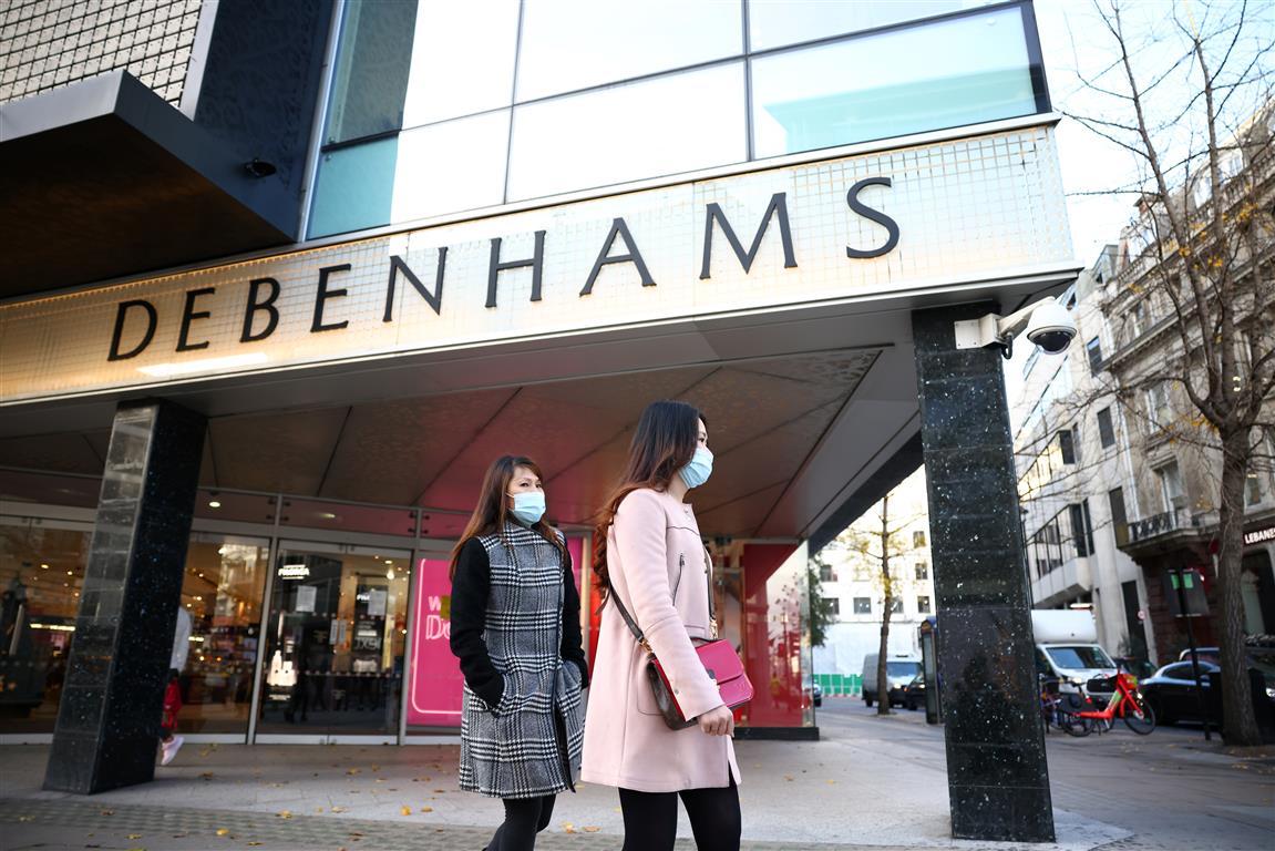 People walk past a Debenhams store on Oxford St in London. Photo: Reuters