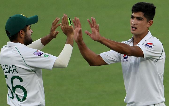 Young Pakistan fast bowler Naseem Shah (right) celebrates taking a wicket in a tour match in...