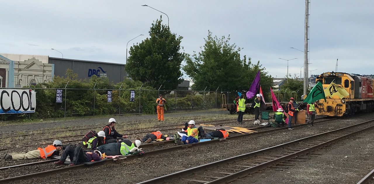 Several of the protesters have locked themselves to the train tracks at Dunedin Railway Station....
