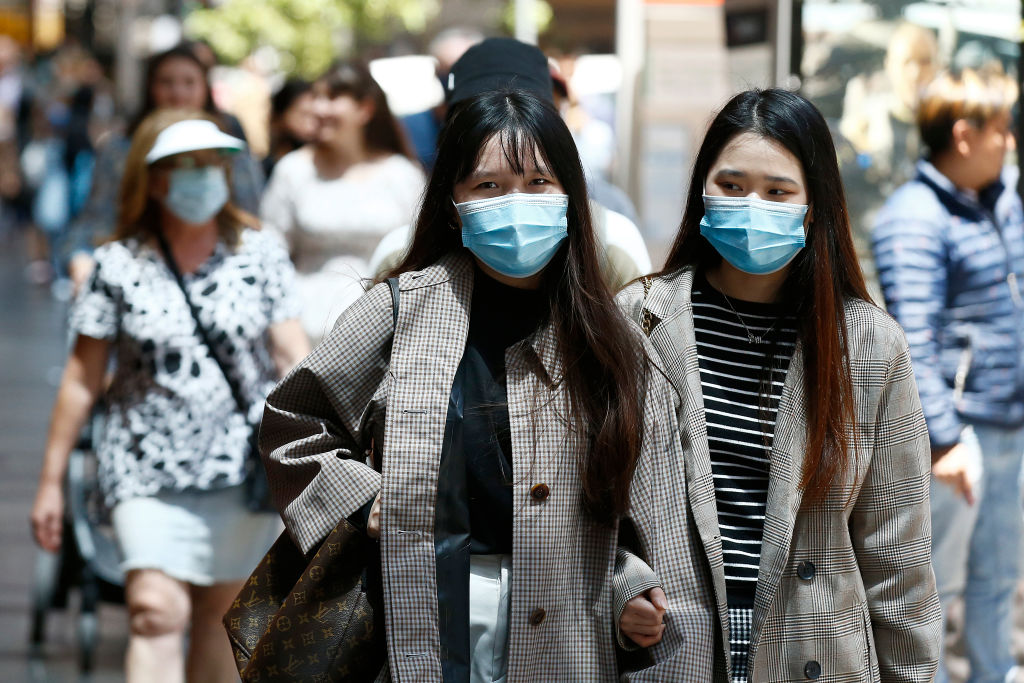 People wear face masks on a street in Melbourne. Photo: Getty
