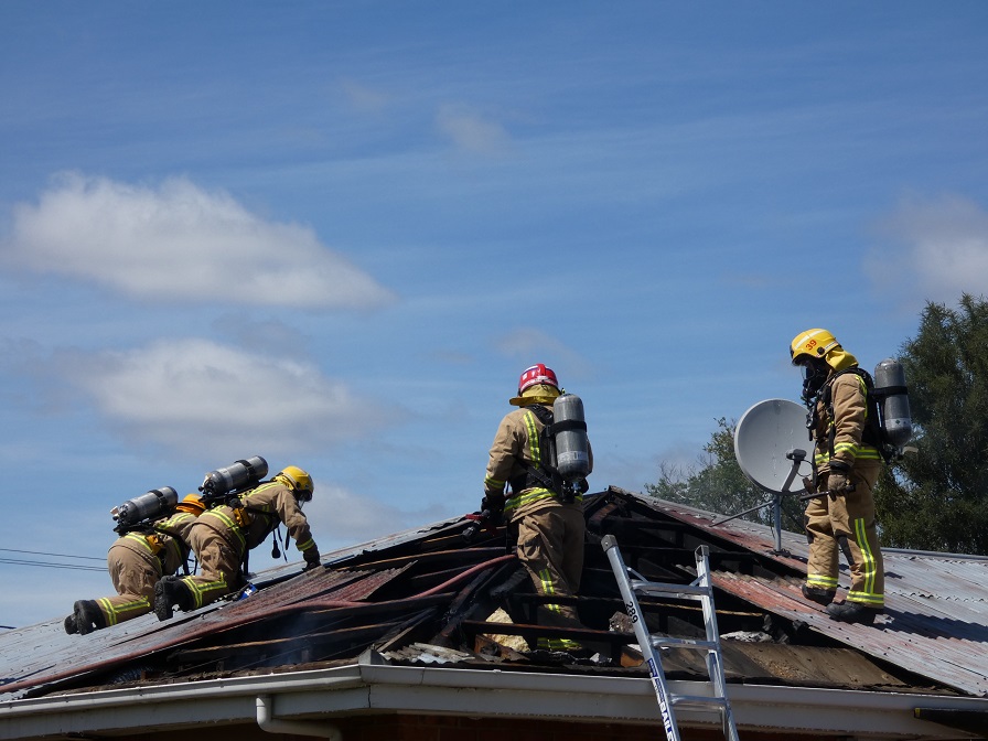 Firefighters on the roof of the property in Alexandra. Photos: Jared Morgan 
