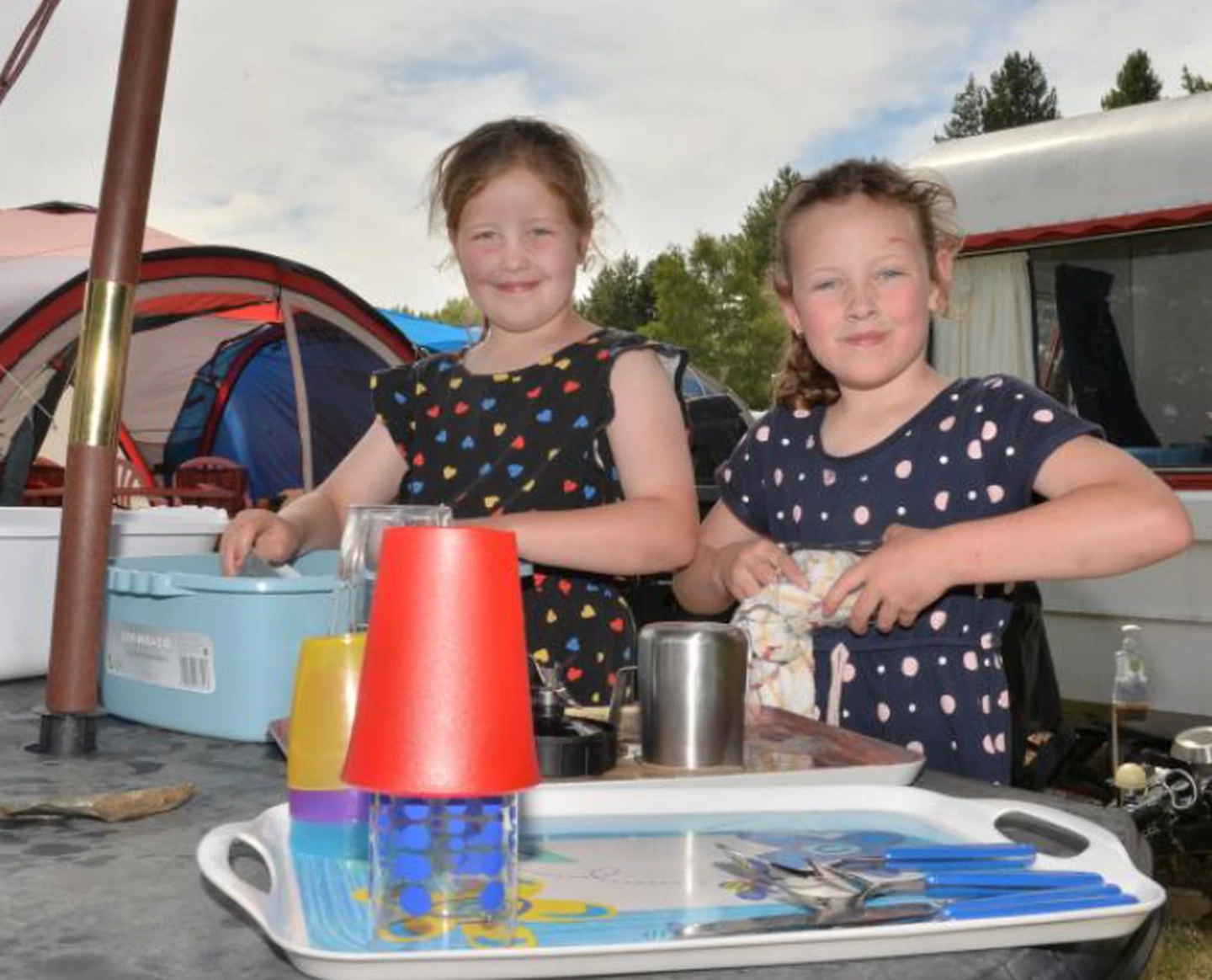 Sisters Aisha (8, left) and Dakota (7) McKellar, of Dunedin, get the camp chores done at the...