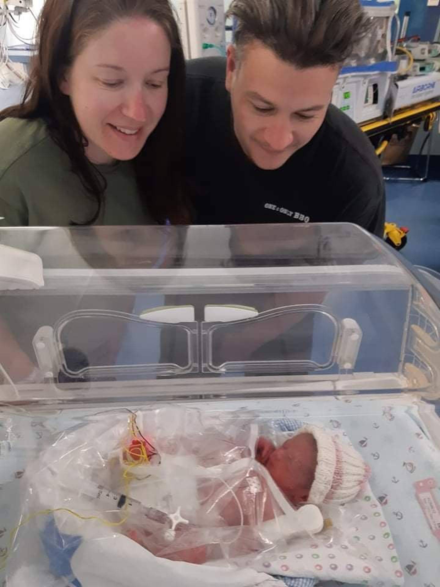 Krysta and Marcus Lord look at their newborn daughter, Kora. Photo: Supplied