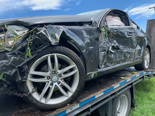 Two tree stumps prevented this car from overturning into a water race. Police say the driver...