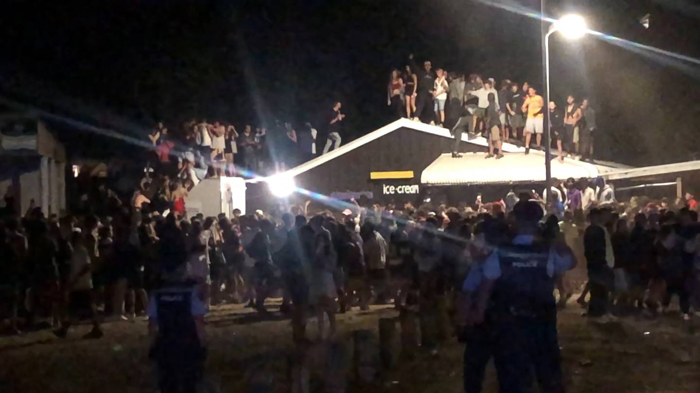 Teens on the roof of a building in Whangamata. Photo: Jane Phare via NZ Herald