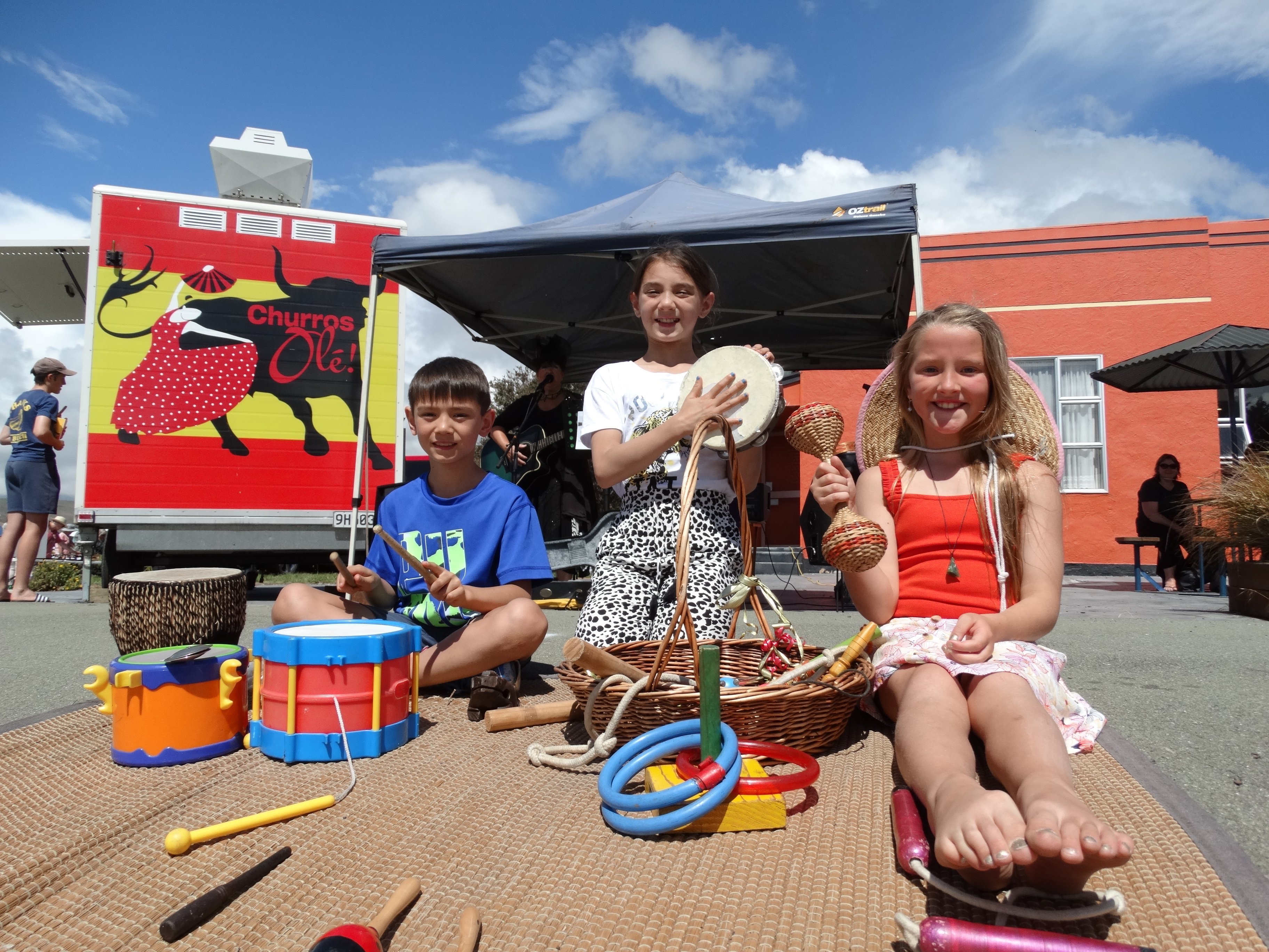 Antony (9) and Annabell (10) Keith, and Nevaeh McLintock (7) help out the buskers at Kurow's...