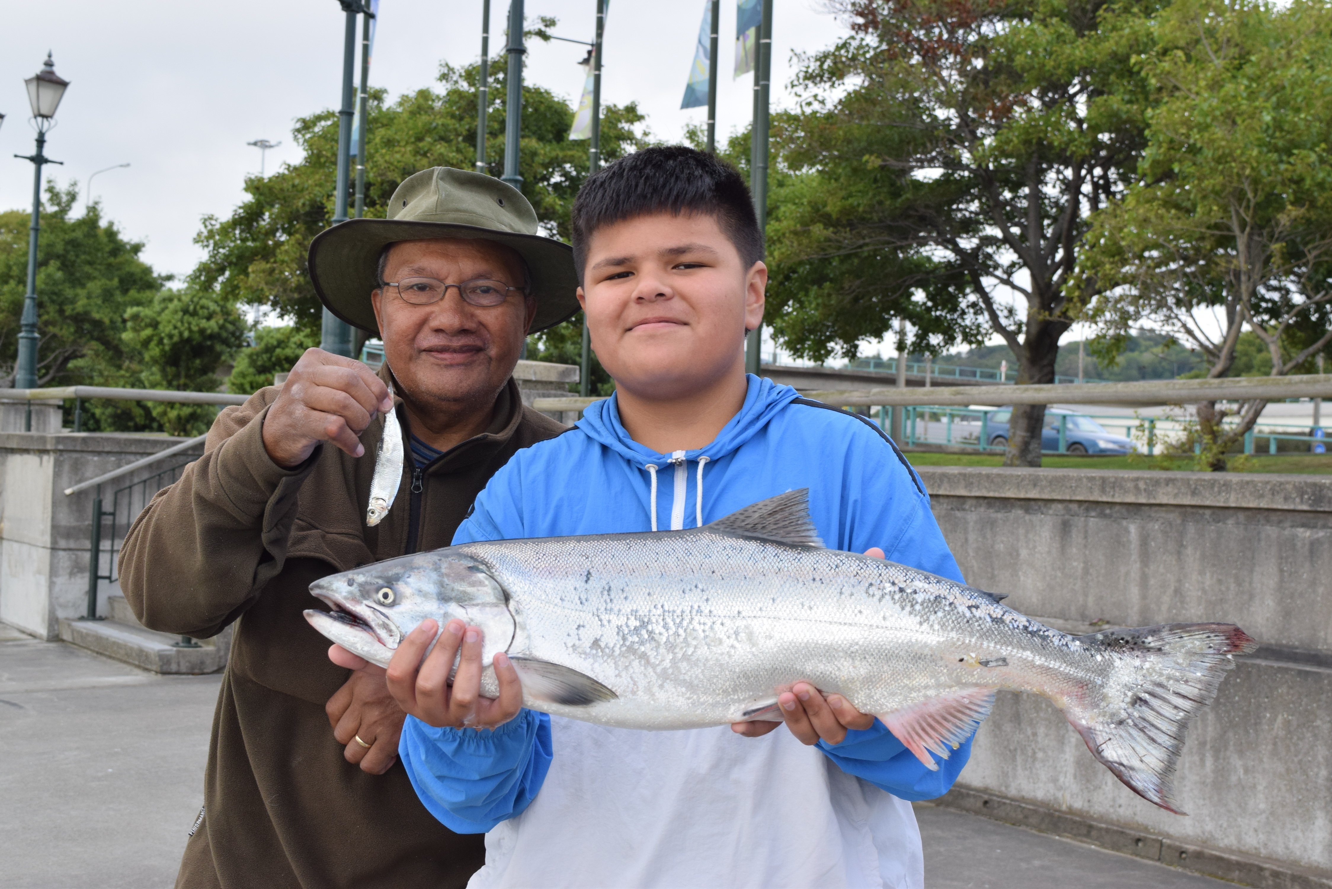 Montell Paulo (12) displays a salmon he caught at Steamer Basin while fishing with his...