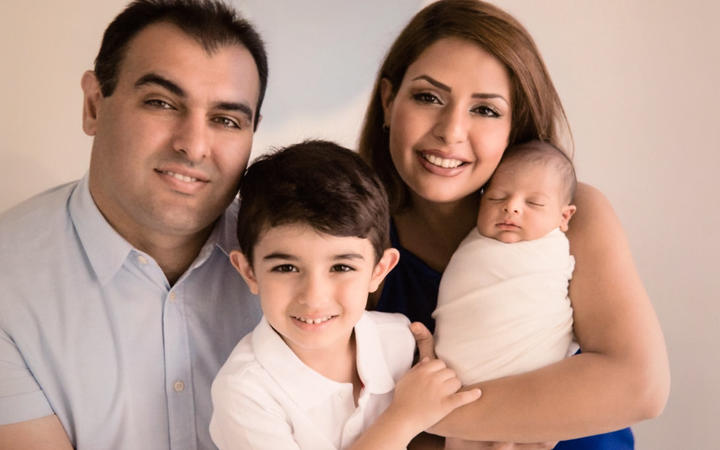 A family picture shows father Siamak, mother Mohadeseh and their sons Arteen (centre) and Radeen ...