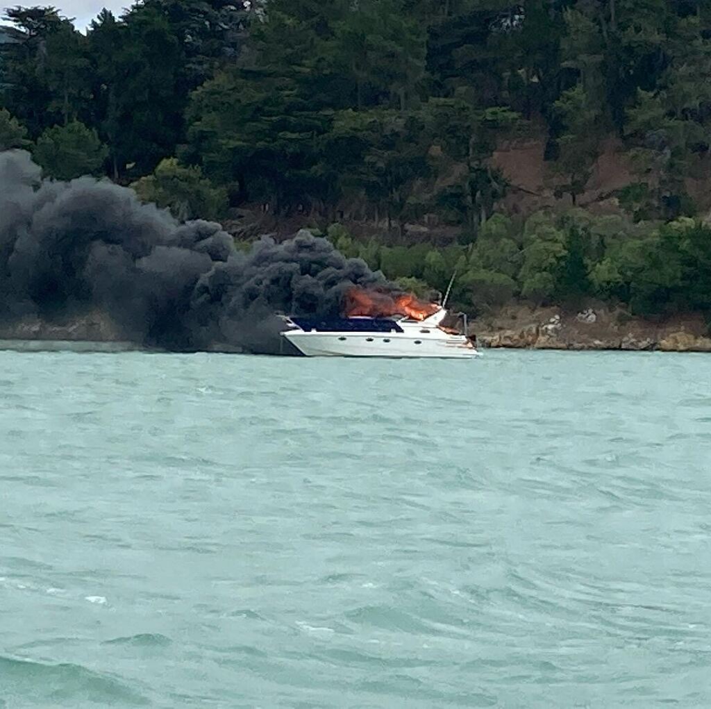 Thick black smoke spread across Lyttelton Harbour after the boat caught fire and sank. Photo: Kim...