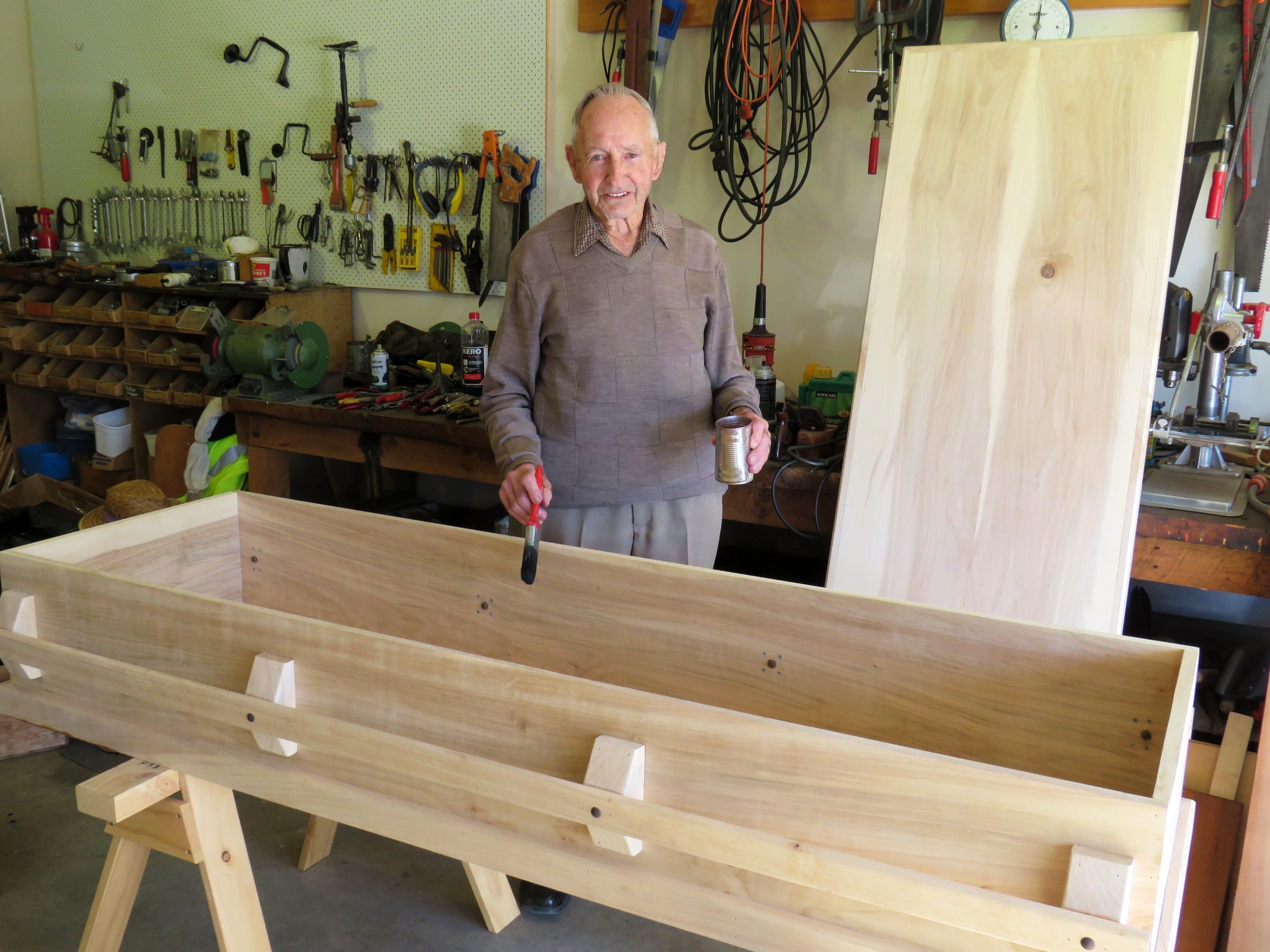 Gilbert Donaldson prepares to add stain to the coffin he has been made from the wood of trees he...