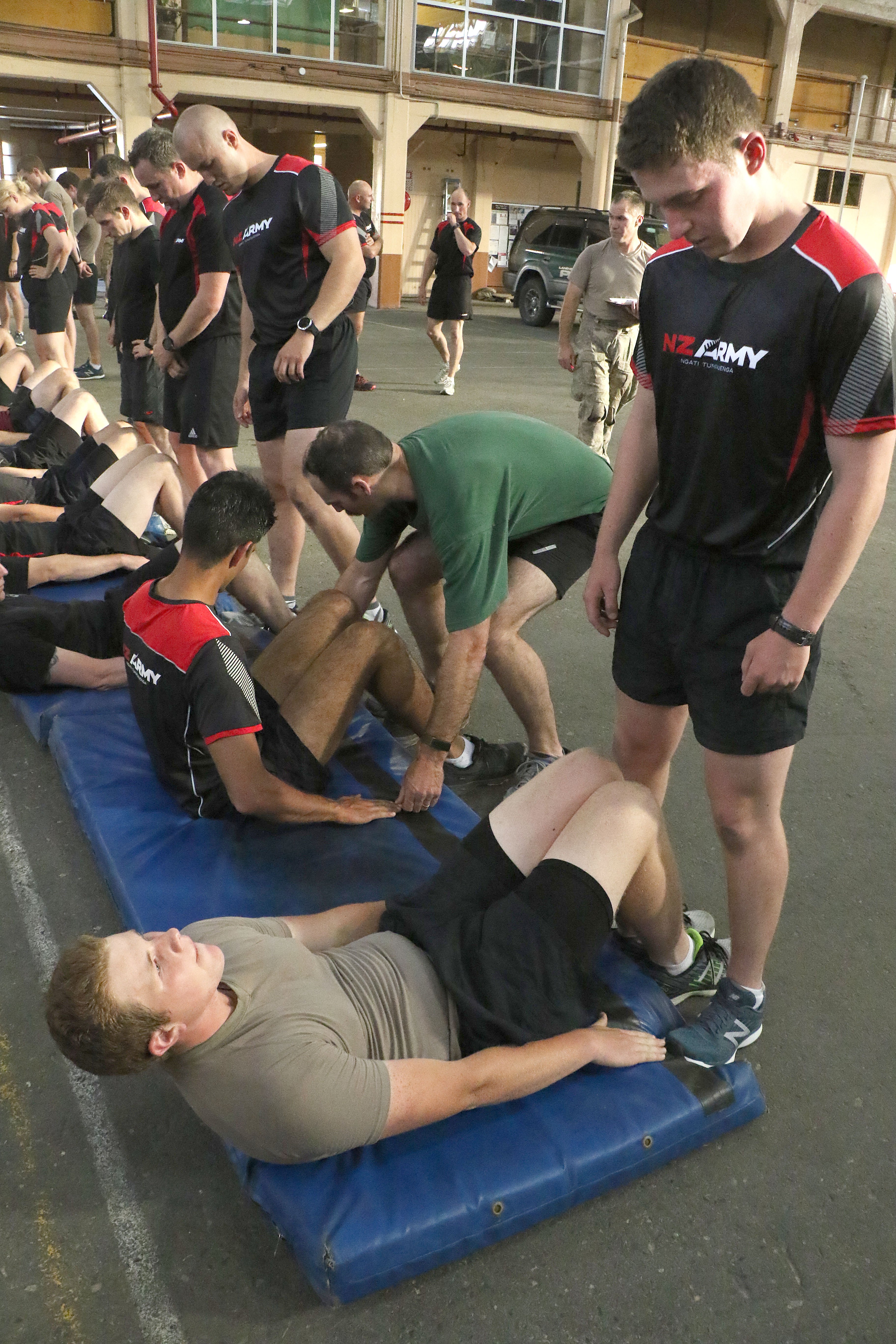 New recruit Private Regan McIntyre completes his set of sit-ups checked by fellow recruit Pte...