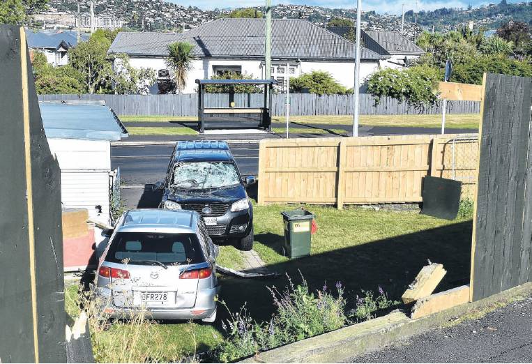 A silver car crashed through Lisa Lindon’s fence and landed on top of her ute on Monday afternoon...