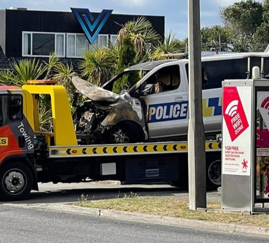 One of the damaged vehicles being towed away from New Brighton police station. Photos: Supplied 